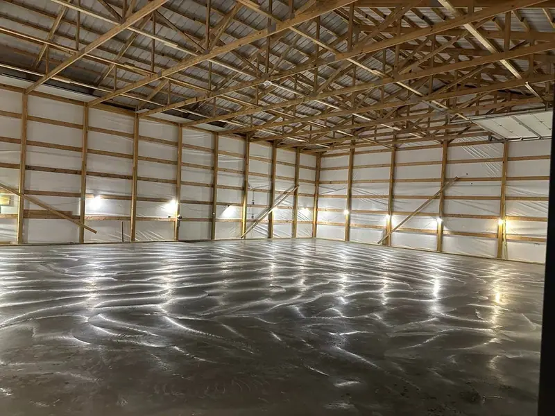 Smooth finished concrete floor inside a large steel-frame building