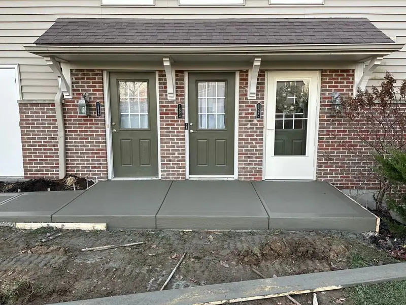 New concrete entry slab at a set of townhome doors