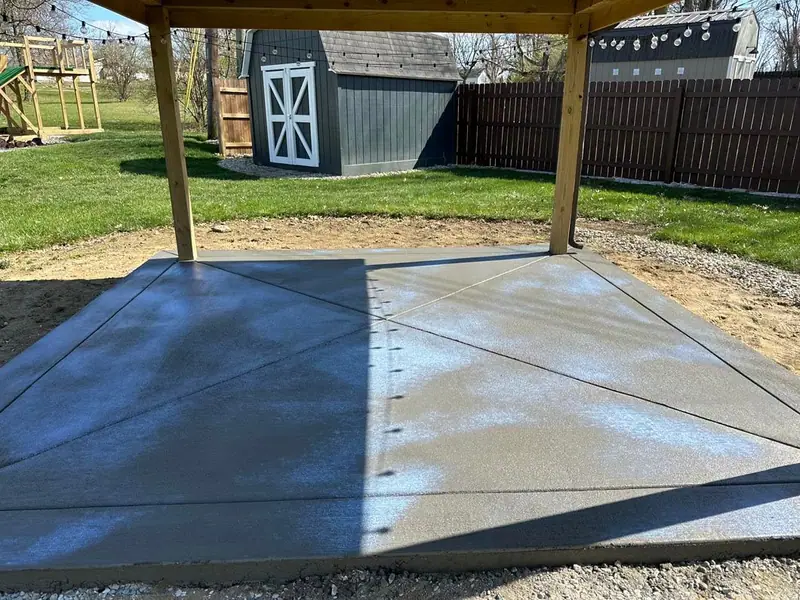 New concrete slab under a wooden gazebo