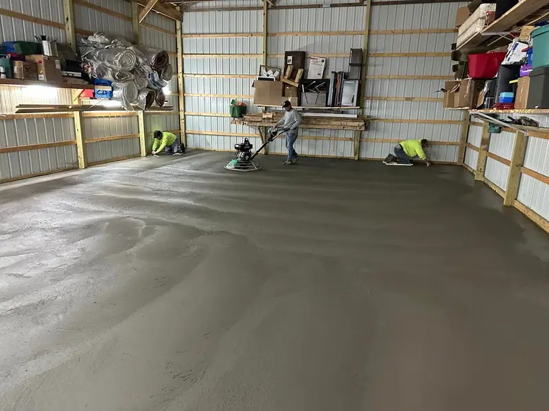 Crew finishing a new concrete shop floor