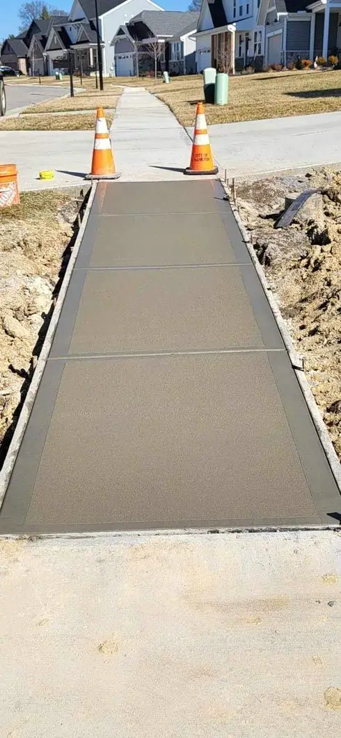 Sidewalk being poured between traffic cones