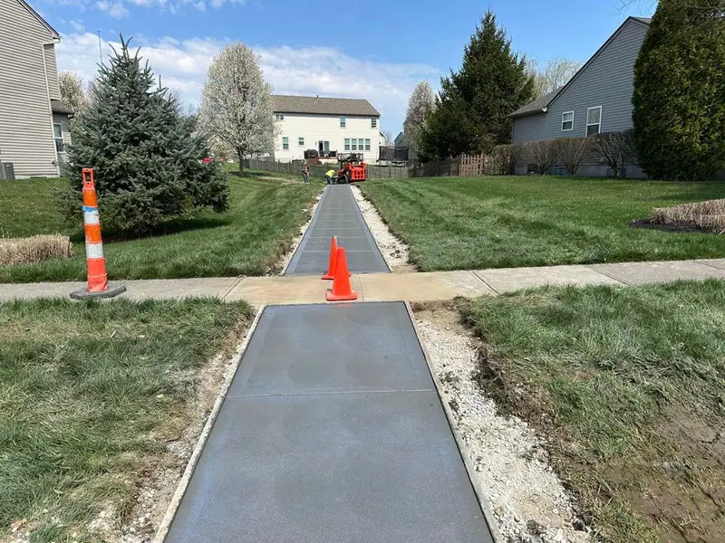 New concrete sidewalk connecting neighborhood green space