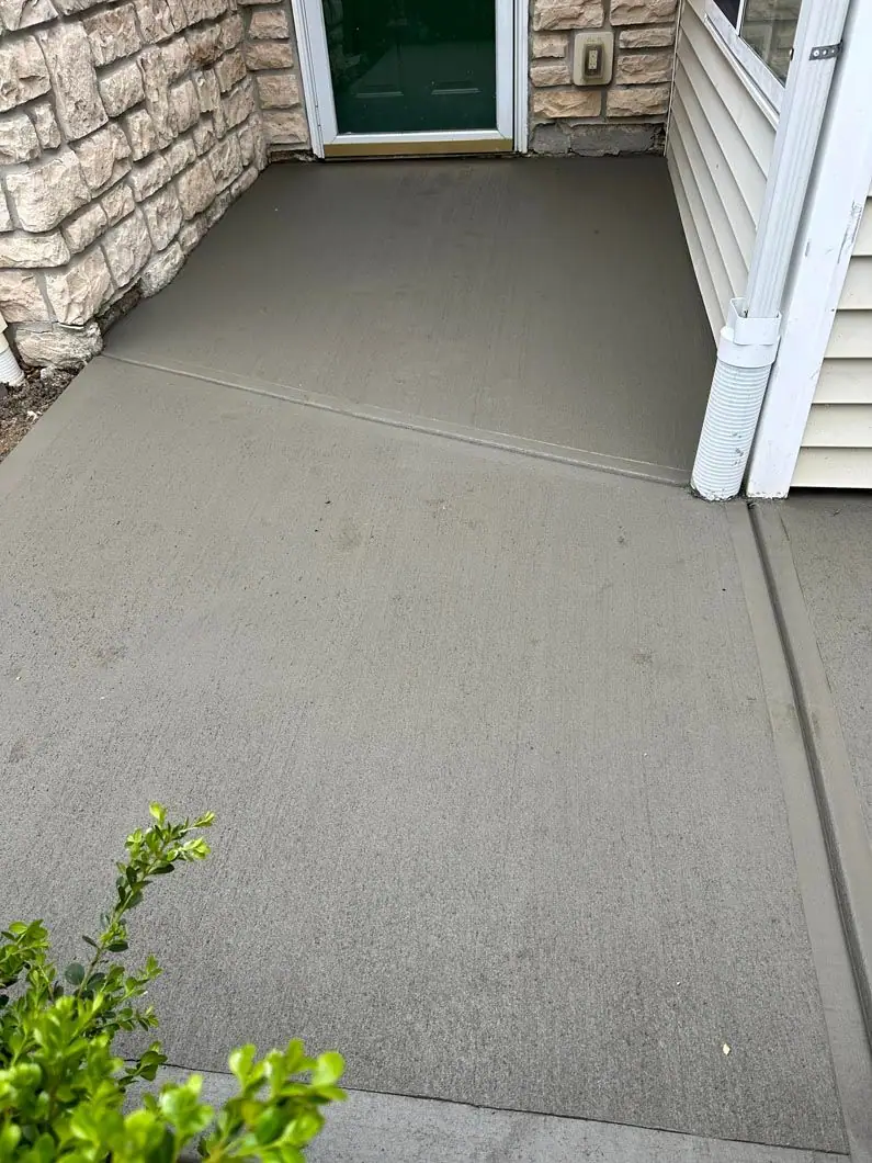 New concrete walkway and stoop at a home side entrance